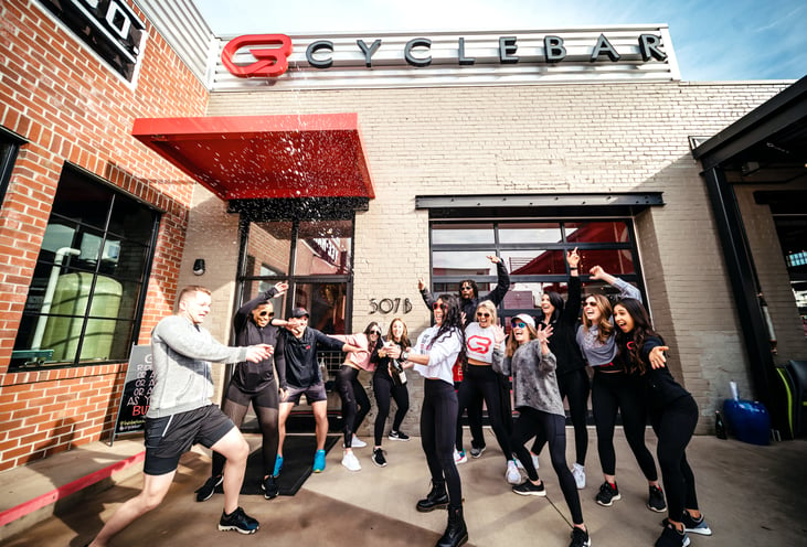 people outside cycle bar in their cycling outfits